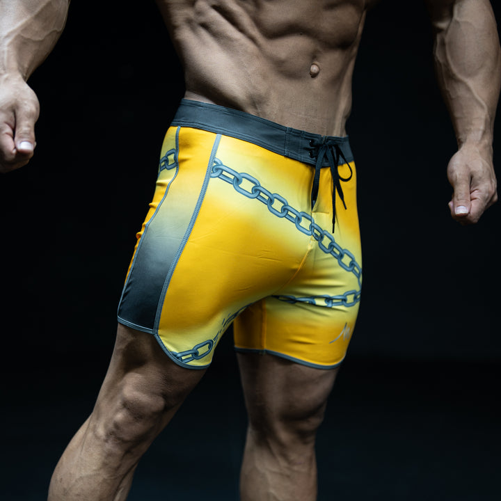 Muscular male athlete wearing Vengeance yellow and black Men&