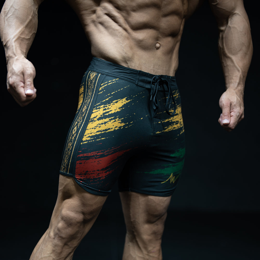Muscular male athlete wearing Legacy black, gold, red, and green Men&